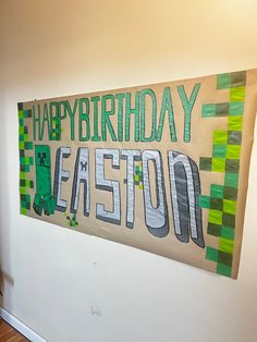 a happy birthday sign hanging on the wall