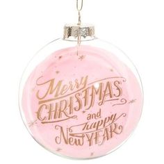 a pink ornament with merry christmas and happy new year written on it