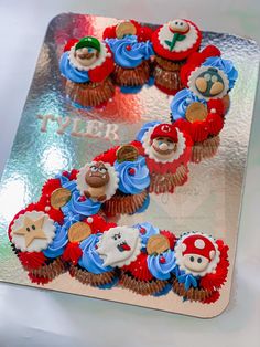 two cupcakes are decorated as mario and luigi's friends on top of each other