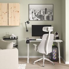 a white chair sitting in front of a computer desk