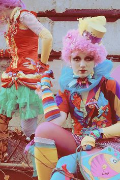 two women dressed up as clowns sitting next to each other