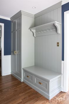 a white bench sitting in the middle of a room