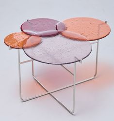 three round tables with different colored tops on each side, one is metal and the other is wood