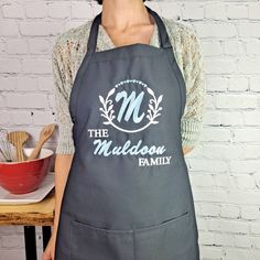 a woman wearing an apron that says the madison family