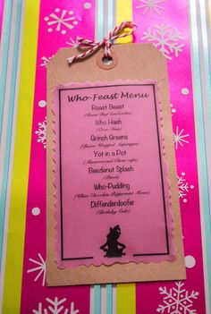 a pink menu with snowflakes on it and a tag that says who - feast menu