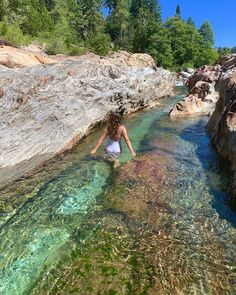 a woman is wading through the clear water