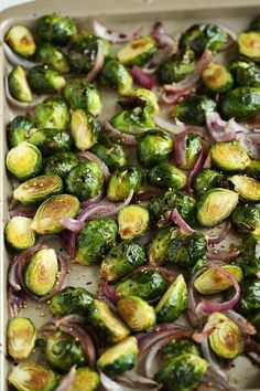 roasted brussel sprouts and onions in a baking dish on a table