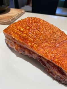 a piece of meat sitting on top of a white plate