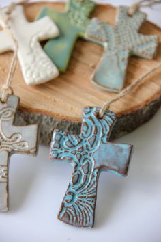 These sweet cross ornaments are perfect to hang on the Christmas tree, tie to a gift, or hang in your window. These precious, handmade crosses are pressed with lace to create unique and beautiful patterns, and are sure to make you and your loved ones smile!• handmade cross ornament• features lace imprint• 3" long, 1.5" wide • customizable colorAll of our pottery is handmade in Chelsea, Alabama by women fleeing homelessness and domestic abuse. 100% of the proceeds from Prodigal Pottery sales supp High School Fundraiser, Cross Ornaments, Easter Pottery, Clay Dough, Pottery Sale, Clay Cross, Clay Christmas Decorations, Ceramic Crosses, Pottery Ornaments