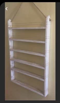 a white wooden shelf hanging on a wall