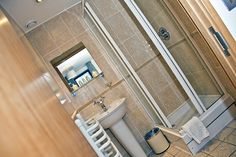 a bathroom with a shower, toilet and sink