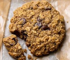 an oatmeal cookie with raisins and chocolate chips on parchment paper