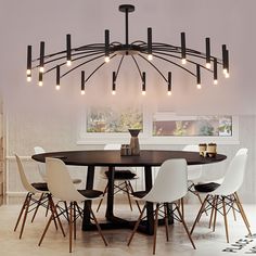 a dining room table with white chairs and lights