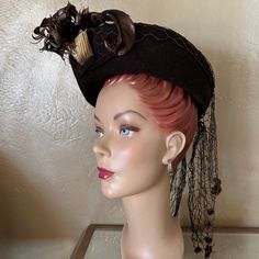 This Stunning Brown Felt Hat Is Composed Of A Medium Height Flat Top Crown Surrounded By A Medium Upturned Brim, From Where A Thick Brown Veil Appears And , Is Tied At The Back, And Ends In Small Brown Pompons. The Front Has A Gold Trim, Which Could Be Bakelite, From Where An Array Of Curly Brown Feathers Emerge. There Is An Elastic Band Attached To The Inside Of The Hat To Kept In Place. This Is A Truly Amazing Piece Of Fashion History! The Wartime 40’s Saw A Huge Variety Of Hats That Were Suit Felt Hat, Brown Gold, Hats Vintage, Gold Trim, Fashion History, Face Shapes, Veil, Trim, Felt