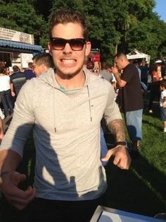 a man standing in front of a table with food on it at an outdoor event