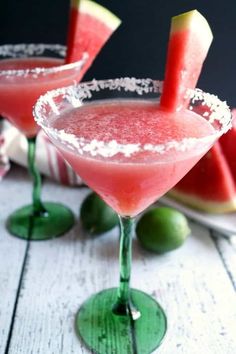 two glasses filled with watermelon margaritas sitting on top of a table