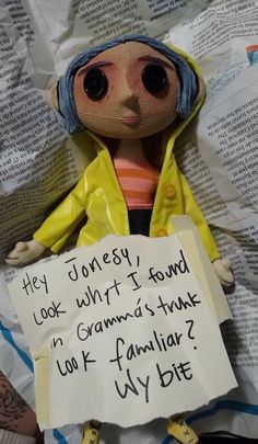 a doll is holding a sign that says hey honesty look what i found in grandma's trunk