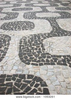 a black and white mosaic pattern on the ground