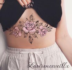 a woman's stomach with pink flowers and leaves on the bottom part of her body