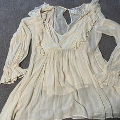 Never Worn, Size 12. Romantic, Ruffled, Full Sleeve With Silver Threads. Chic Cream Blouse For Vacation, Cream V-neck Party Blouse, Cream V-neck Blouse For Party, Cream Blouse For Summer Party, Summer V-neck Blouse For Party, Flirty V-neck Blouse For Day Out, Chic Flowy Cream Tops, Chic V-neck Top For Daytime, Chic Daytime V-neck Top