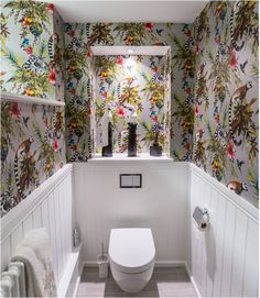 a white toilet sitting in a bathroom next to a radiator