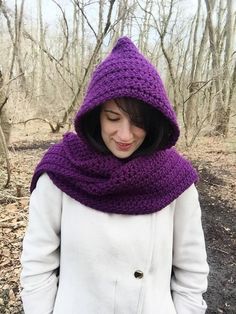 a woman wearing a purple knitted hooded scarf