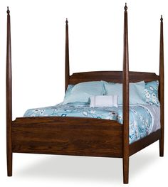 a wooden bed with four posts and blue comforter on the bottom, in front of a white background