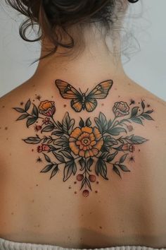 the back of a woman's neck with flowers and butterflies on her upper part