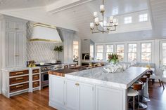 a large kitchen with an island in the middle and lots of counter space on one side