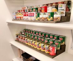 an organized pantry with canned food items on shelves