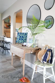 a chair and table in a room with mirrors on the wall