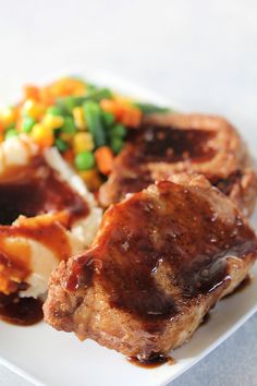 a white plate topped with meat and veggies