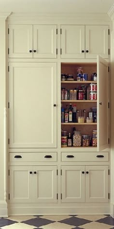 an image of a kitchen pantry with lots of cupboards and shelves in it's center