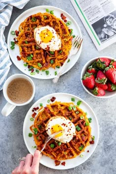 two plates with waffles topped with eggs and bacon next to a cup of coffee