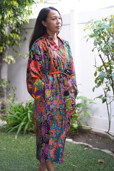 This is a long washable printed batik robe/ kimono handmade by artisans, thick duster and home jacket. Eco-friendly, upcycled fabric for conscious fashion. The fabric was sourced from surroundings clothing manufacturer that would have been otherwise discarded. Because of the upcycled material and handmade nature of this item, each batik quilt kimono is not alike. The print will be of slightly different pattern and color but in variation of black, blue, pink, purple, green mix pattern. This thick