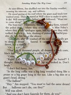 a book page with some beads on it and an image of the word love written in white