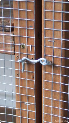 two wooden doors with metal bars on them