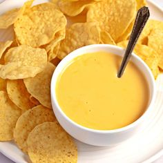 a white plate topped with chips and dip