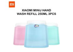 three different colored containers with lids for soaps and hand washes on white background