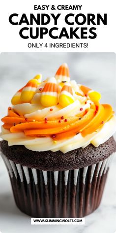 a chocolate cupcake with candy corn on top and white frosting in the middle