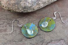 Art Paper Gelli Printed paper and Prehnite stones all suspended from Sterling Silver Fishhook Ear wires.  Gelli Printed Art Paper is the base for these unique earrings.   One-of-a-kind earrings.   Beautiful Light green Prehnite teardrop stones.  I can change the ear wires if you prefer long brass or Silver Plate kidney style wires.    Earrings measures approximately 1.75 inches long and 1 inch at widest part. Handmade Artsy Teardrop Jewelry, Artistic Teardrop Soldered Earrings, Earrings Art, Printed Art, Fish Hook, Unique Earrings, Printed Paper, Ear Wires, Art Paper