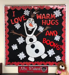 a sign that says i love warm hugs and books with a snowman on it