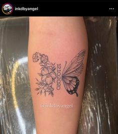 a black and white photo of a butterfly with flowers on it's back leg