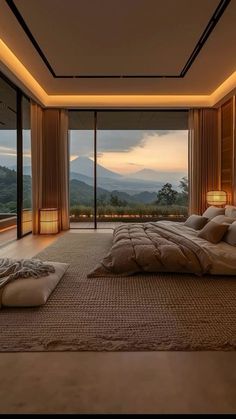 a large bed sitting in the middle of a bedroom next to a tall glass window