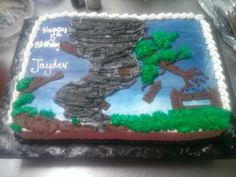 a birthday cake is decorated with an image of a tree