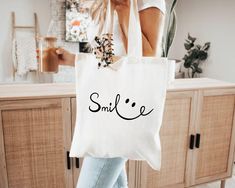 Smile Tote Bag, Happy Tote Bag, Custom Tote Bag, Cotton Tote Bag, Trending Tote Bag, Aesthetic Tote Bag, Canvas Tote Bag, Cute Tote Bag Thank you so much for choosing us! How To Order 1️⃣ Please review all the information provided before placing an order. 2️⃣ Select the shirt type and size using the drop down menu. 3️⃣ Select the color of the shirt using the following drop down menu. 4️⃣ Once all your desired items are in your cart you may complete your order by entering your payment method, des Trending Totes, Custom Tote Bags, Cute Tote Bags, Custom Bags, Cotton Tote Bags, Canvas Tote, Types Of Shirts, Tote Bag, Accessory Gift