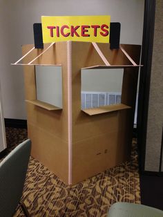 a cardboard box with a sign on it that says tickets