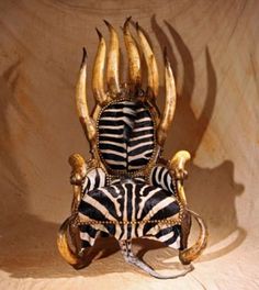 a chair made out of zebra's skin and horns