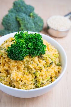 a bowl filled with broccoli on top of a wooden table