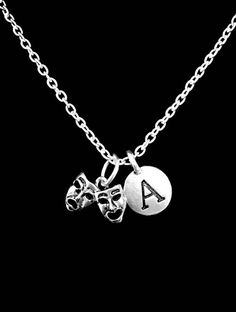 The charms are silver color. The mask charm is approx 12mm x 16mm. The chain is silver plated link chain and is 18" long. Has lobster clasp closure on the chain. Charms are Pewter. Chain made of silver plated alloy. Gorgeous!!!-Ships with gift packaging.-Invoices are not included in packages unless requested.-Birthstone charms can be purchased for this piece with this link:  https://www.etsy.com/listing/195923344-Initial/ Letter charms can be purchased for this pieces with this link:  https://ww